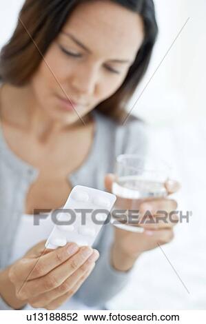 Young woman holding blister pack View Large Photo Image Stock Image - Young woman holding blister pack. Fotosearch