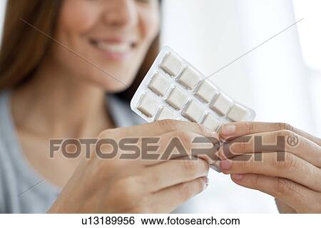 Young woman holding nicotine gum View Large Photo Image Stock Photograph - Young woman holding nicotine gum. Fotosearch