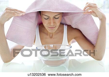 Young woman inhaling steam View Large Photo Image Stock Photograph - Young woman inhaling steam. Fotosearch