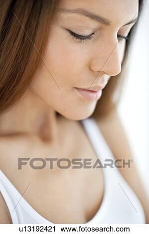 Young woman looking down View Large Photo Image Stock Image - Young woman looking down. Fotosearch