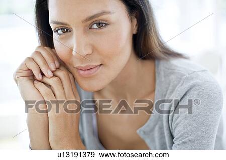 Young woman smiling towards camera View Large Photo Image Stock Photo - Young woman smiling towards camera. Fotosearch