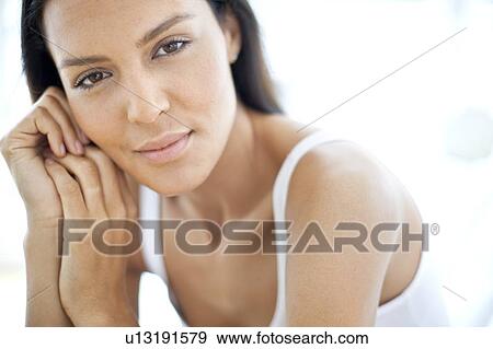 Young woman smiling towards camera View Large Photo Image Stock Photo - Young woman smiling towards camera. Fotosearch