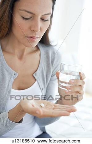 Young woman taking medicine View Large Photo Image Stock Image - Young woman taking medicine. Fotosearch
