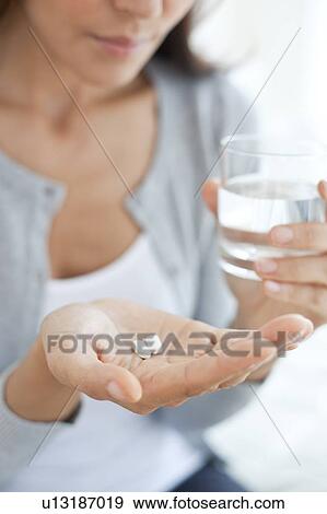 Young woman taking medicine View Large Photo Image Stock Photo - Young woman taking medicine. Fotosearch