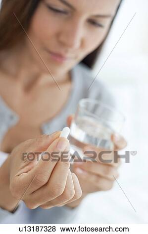 Young woman taking medicine View Large Photo Image Stock Photo - Young woman taking medicine. Fotosearch