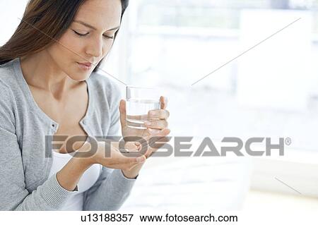 Young woman taking medicine View Large Photo Image Stock Photo - Young woman taking medicine. Fotosearch