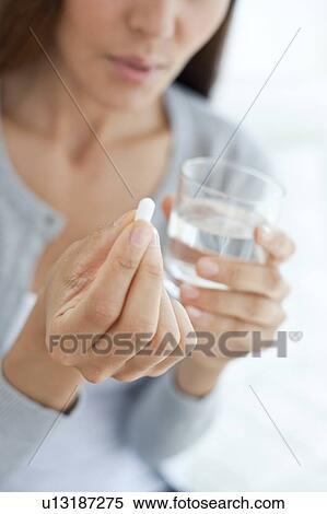 Young woman taking medicine View Large Photo Image Stock Photography - Young woman taking medicine. Fotosearch