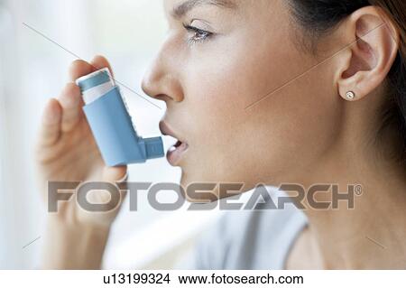Young woman using inhaler View Large Photo Image Picture - Young woman using inhaler. Fotosearch