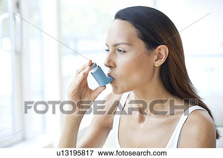 Young woman using inhaler View Large Photo Image Stock Photo - Young woman using inhaler. Fotosearch