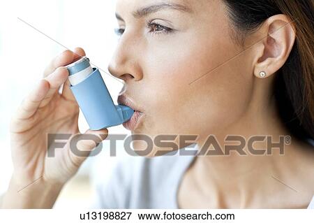 Young woman using inhaler View Large Photo Image Stock Photo - Young woman using inhaler. Fotosearch