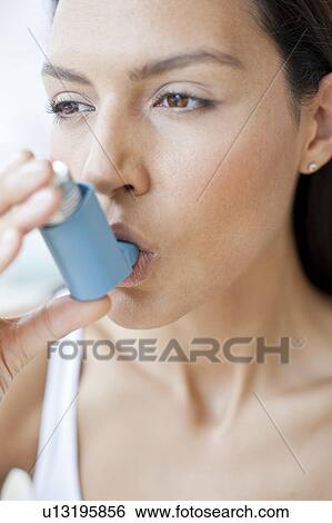 Young woman using inhaler View Large Photo Image Stock Photograph - Young woman using inhaler. Fotosearch