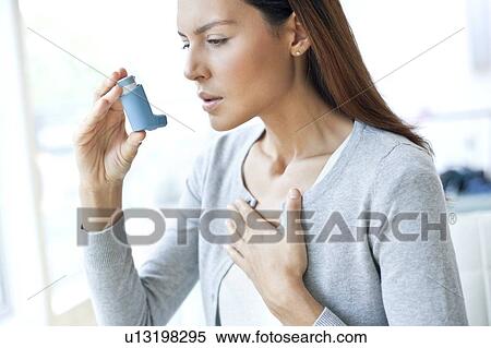 Young woman using inhaler touching chest View Large Photo Image Stock Photography - Young woman using inhaler touching chest. Fotosearch