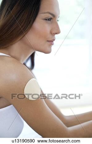 Young woman wearing nicotine patch View Large Photo Image Stock Image - Young woman wearing nicotine patch. Fotosearch