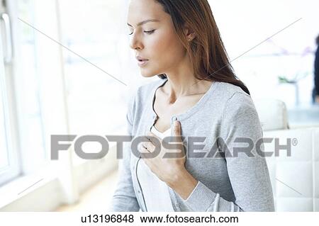 Young woman with hand on chest View Large Photo Image Stock Photo - Young woman with hand on chest. Fotosearch