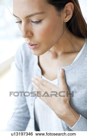 Young woman with hand on chest View Large Photo Image Stock Photograph - Young woman with hand on chest. Fotosearch