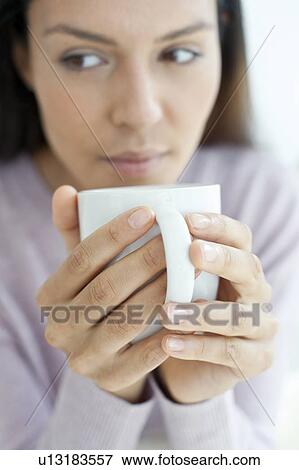 Stock Photo - Young woman with hot drink. Fotosearch