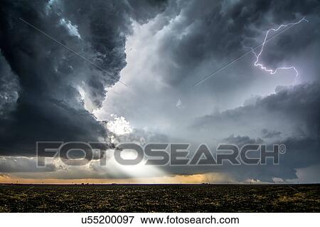 A supercell and tornado under the base of a storm, with beams of sunlight and lightning emerging from storm layers, Dodge City, Kansas View Large Photo Image Stock Photo - A supercell and tornado under the base of a storm, with beams of sunlight and lightning emerging from storm layers, Dodge City, Kansas. Fotosearch