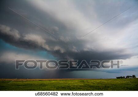 Stock Image - A supercell storm assumes a green colour after producing tornadoes near Felt, Oklahoma. Fotosearch