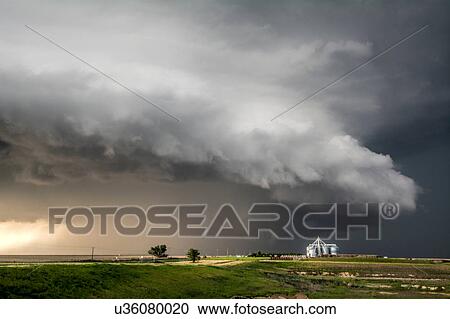 Stock Image - A tornado-producing supercell thunderstorm spinning over ranch land near Leoti, Kansas. Fotosearch