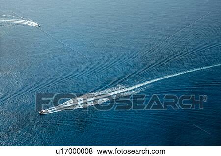 Stock Photo - Aerial view of boats leaving trails in sea, Zante, Greece. Fotosearch