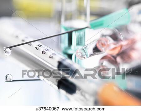 Stock Photo - Ampoule and medical drug-filled syringe. Fotosearch