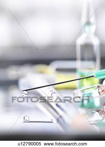 Stock Photography - Ampoule and medical drug-filled syringe. Fotosearch