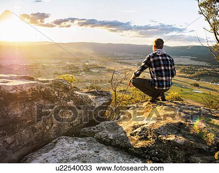 Stock Image - Australia, New South Wales, Man looking at view on Mount York. Fotosearch