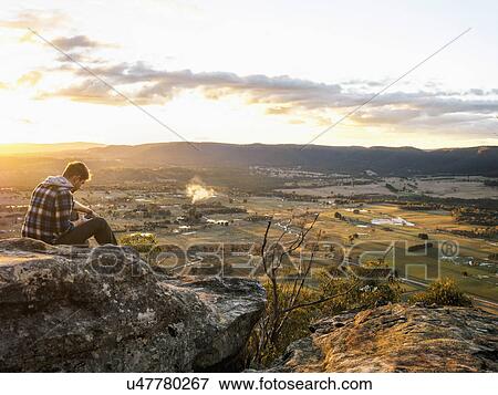 Stock Photo - Australia, New South Wales, Man looking at view on Mount York. Fotosearch