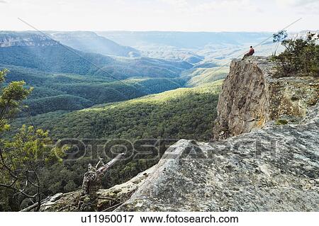 Stock Photo - Australia, New South Wales, Narrow Neck Peninsula, Katoomba, Man looking at view in Blue Mountains. Fotosearch