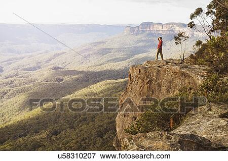 Stock Photo - Australia, New South Wales, Narrow Neck Peninsula, Katoomba, Man looking at view in Blue Mountains. Fotosearch