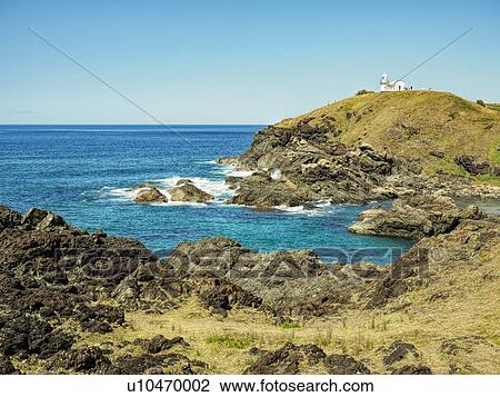 Stock Image - Australia, New South Wales, Port Macquarie, Lighthouse on rocky coat. Fotosearch