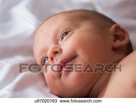 Baby boy (0-1 months) lying on bed View Large Photo Image Stock Image - Baby boy (0-1 months) lying on bed. Fotosearch
