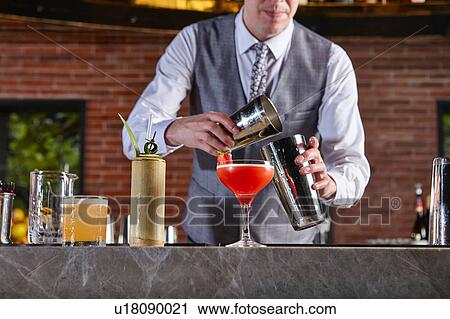 Bartender preparing cocktail View Large Photo Image Stock Image - Bartender preparing cocktail. Fotosearch
