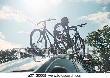 Bicycles on bike rack on car roof View Large Photo Image Stock Photography - Bicycles on bike rack on car roof. Fotosearch