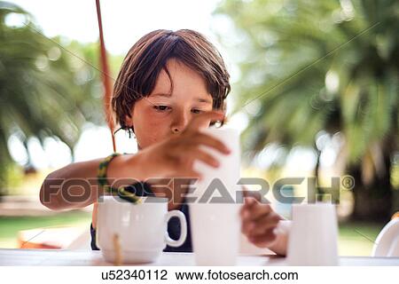 Boy balancing plastic cups View Large Photo Image Stock Image - Boy balancing plastic cups. Fotosearch
