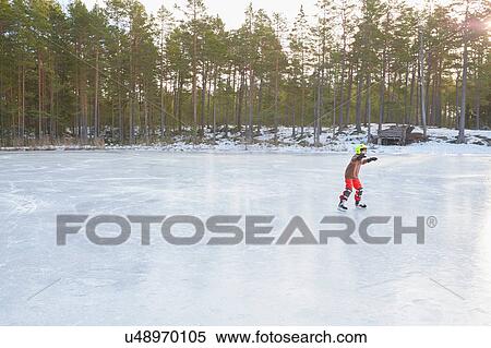 Boy ice skating on frozen lake, Gavle, Sweden View Large Photo Image Stock Photography - Boy ice skating on frozen lake, Gavle, Sweden. Fotosearch