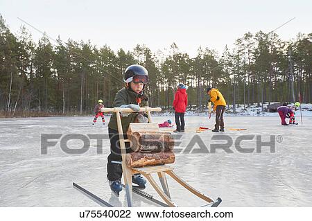 Boy learning to ice skate with kicksled on frozen lake, Gavle, Sweden View Large Photo Image Stock Image - Boy learning to ice skate with kicksled on frozen lake, Gavle, Sweden. Fotosearch