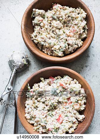 Stock Photo - Bulgur salad in wooden bowl with scoop. Fotosearch