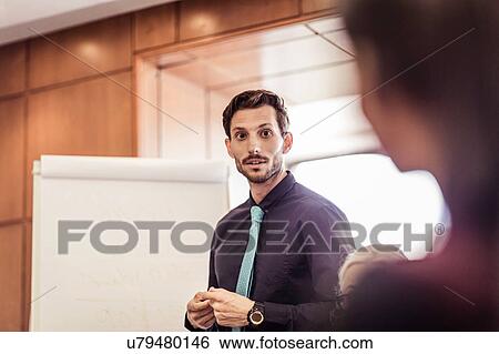 Businessman questioning at boardroom presentation View Large Photo Image Stock Photograph - Businessman questioning at boardroom presentation. Fotosearch