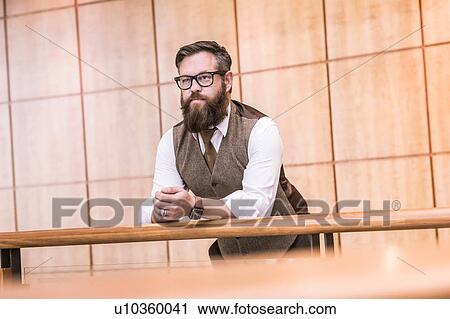 Businessman wearing tweed waistcoat looking out from office balcony View Large Photo Image Stock Image - Businessman wearing tweed waistcoat looking out from office balcony. Fotosearch