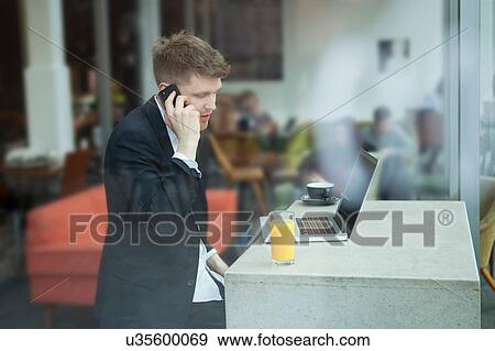 Businessman working with laptop in cafe View Large Photo Image Stock Photo - Businessman working with laptop in cafe. Fotosearch