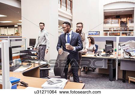Businessmen leaving office desk View Large Photo Image Picture - Businessmen leaving office desk. Fotosearch