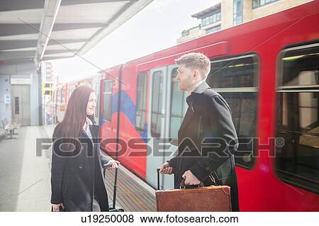 Businesswoman and businessman in Docklands Light Railway train station, London View Large Photo Image Stock Photo - Businesswoman and businessman in Docklands Light Railway train station, London. Fotosearch