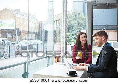 Businesswoman and businessman working with laptop in cafe View Large Photo Image Stock Image - Businesswoman and businessman working with laptop in cafe. Fotosearch