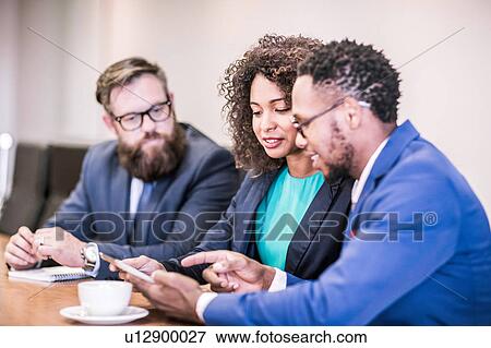 Businesswoman and businessmen using digital tablet in board meeting View Large Photo Image Stock Photo - Businesswoman and businessmen using digital tablet in board meeting. Fotosearch