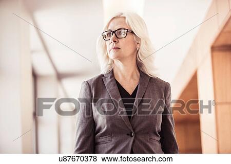Stock Photo - Businesswoman in office corridor. Fotosearch