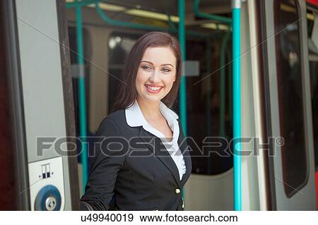 Businesswoman stepping off Docklands Light Railway train, London View Large Photo Image Stock Photo - Businesswoman stepping off Docklands Light Railway train, London. Fotosearch