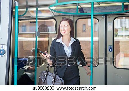 Businesswoman travelling in Docklands Light Railway train, London View Large Photo Image Stock Image - Businesswoman travelling in Docklands Light Railway train, London. Fotosearch