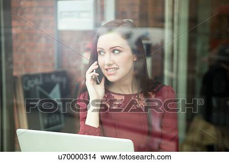 Picture - Businesswoman working with laptop in cafe. Fotosearch