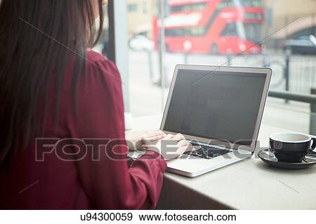 Businesswoman working with laptop in cafe View Large Photo Image Stock Photo - Businesswoman working with laptop in cafe. Fotosearch